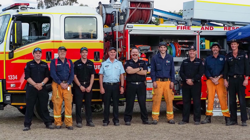 people standing in front of fire truck