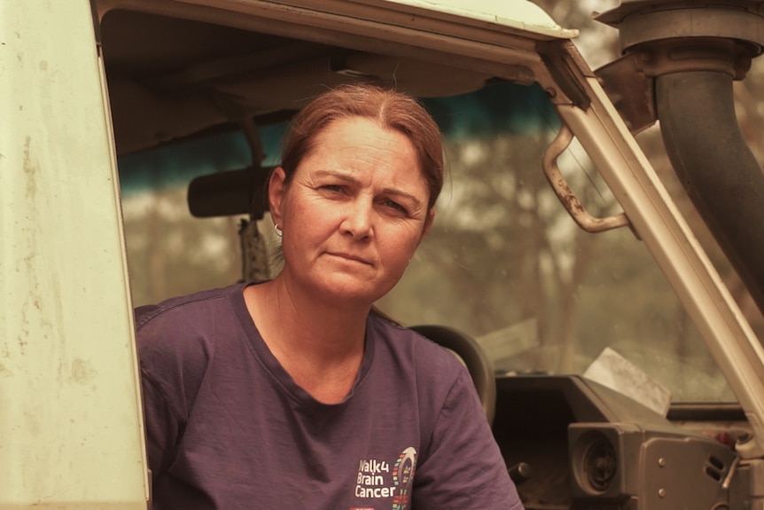 A woman looks at the camera though a smoky lens