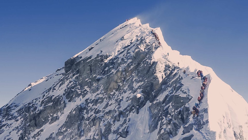 Dozens of mountain climbers on a section of Mount Everest known as The Cornice Traverse.