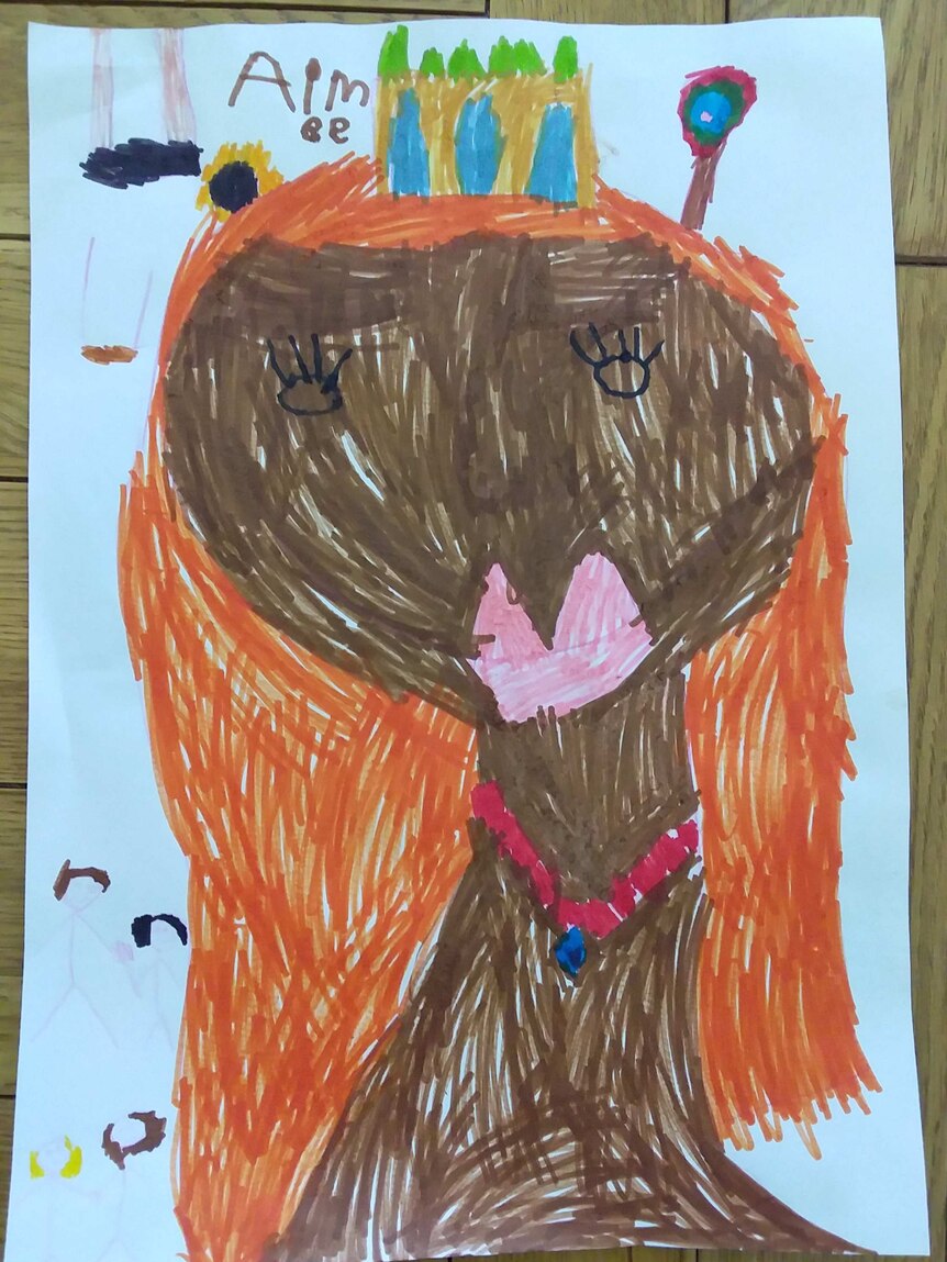 A child's drawing of a girl's face wearing a crown.