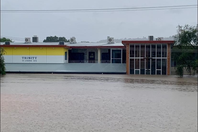 A two-story school building with flood water up to the second floor.