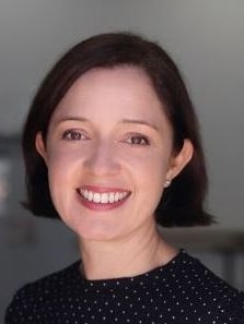 A woman with short brown hair smiling