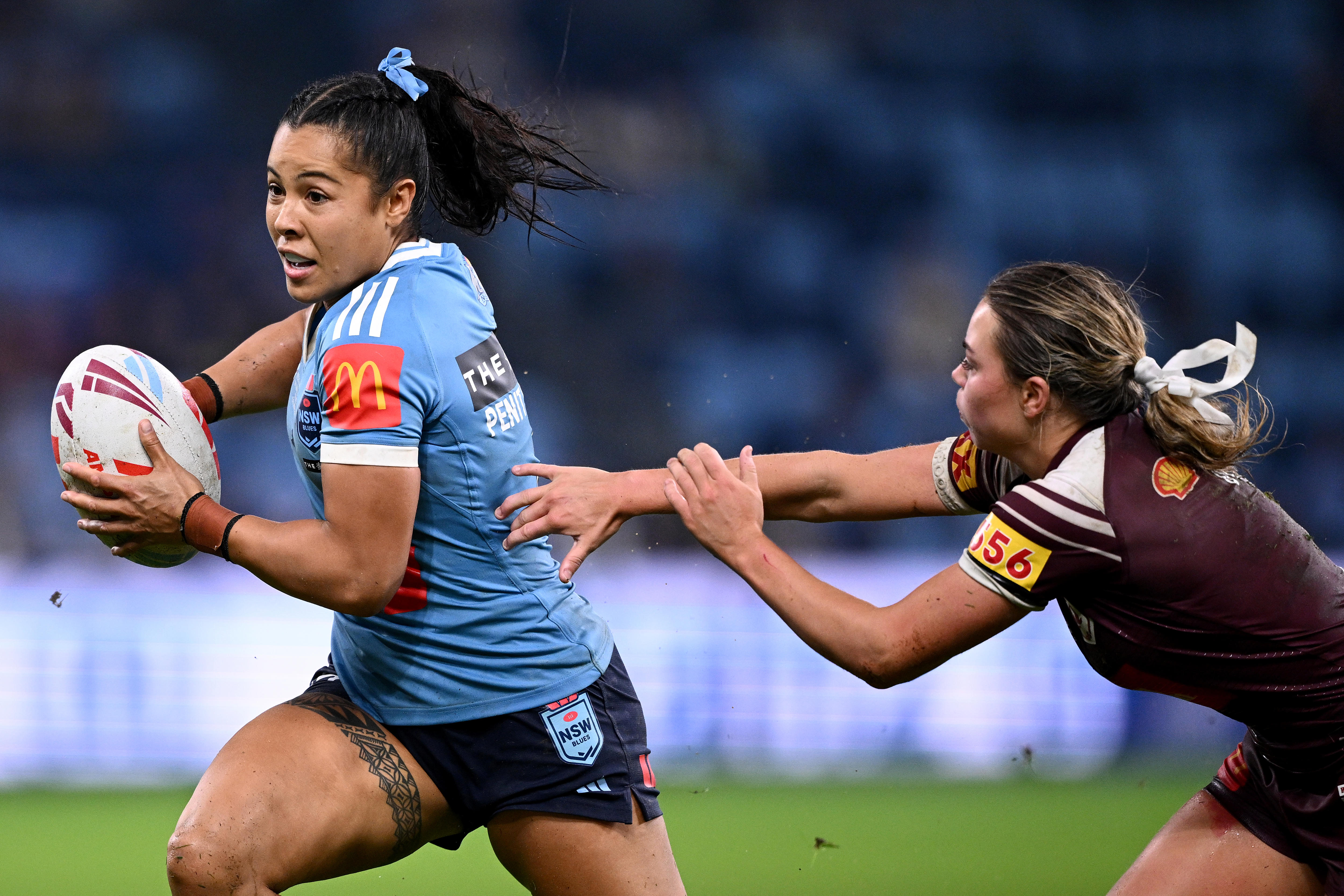 Gray runs the ball during a rugby league match, wars blue jersey.