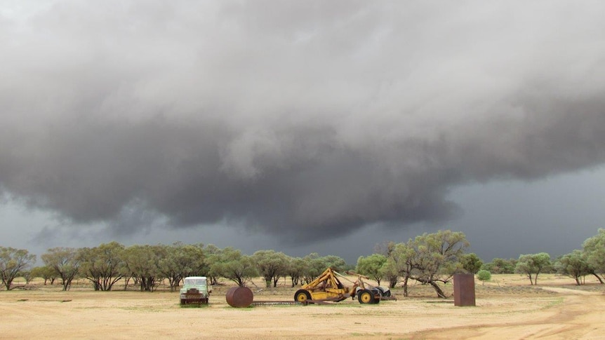 Black storm clouds hang over a paddock at El Kantara.