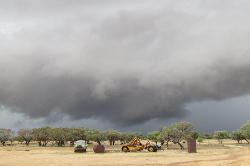Black storm clouds hang over a paddock at El Kantara.