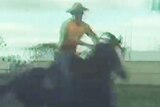 A still from a video of a man riding a horse.