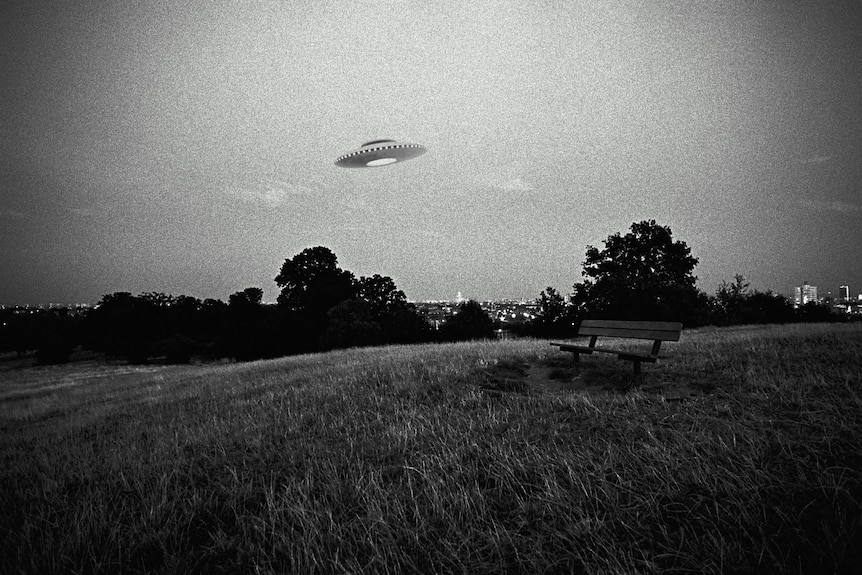 Black and white image of a space ship flying over a city park.