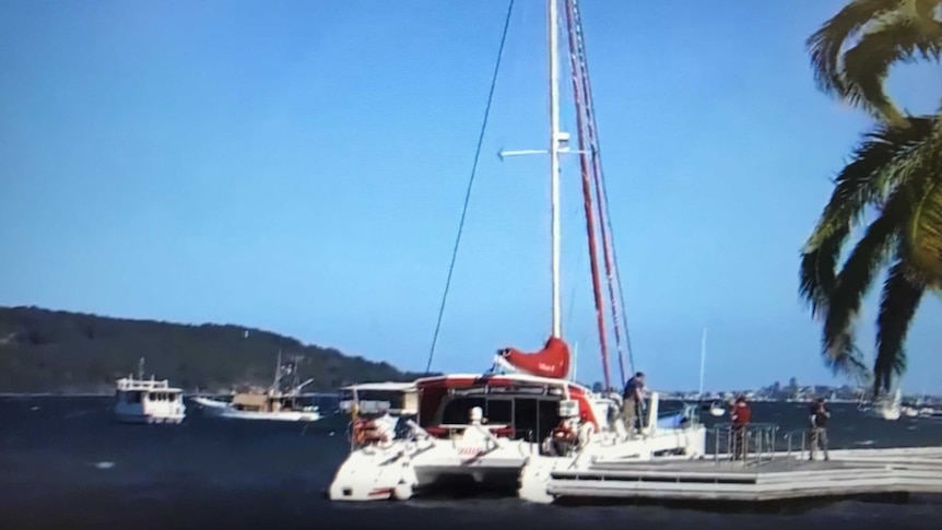 Twin-hulled yacht moored at a jetty
