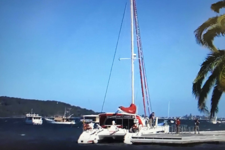 Twin-hulled yacht moored at a jetty