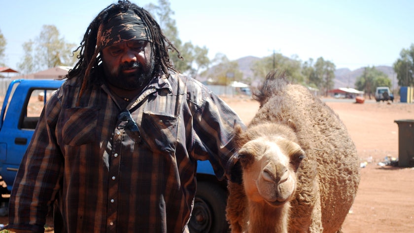 Docker River local Lyle Kenny poses for photos with his pet camel Lasseter