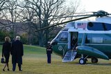 Trumps walk towards Marine One helicopter