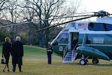 Trumps walk towards Marine One helicopter