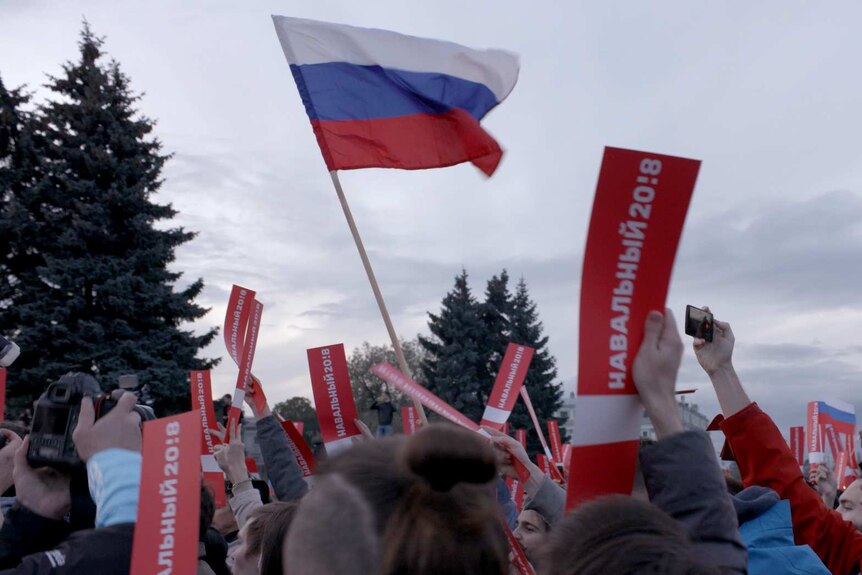 Russian flag flying above people's heads