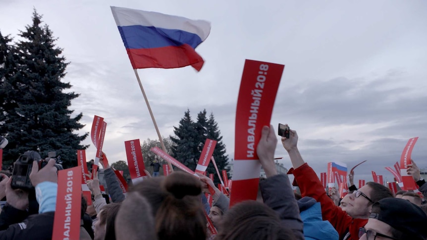 Russian flag flying above people's heads