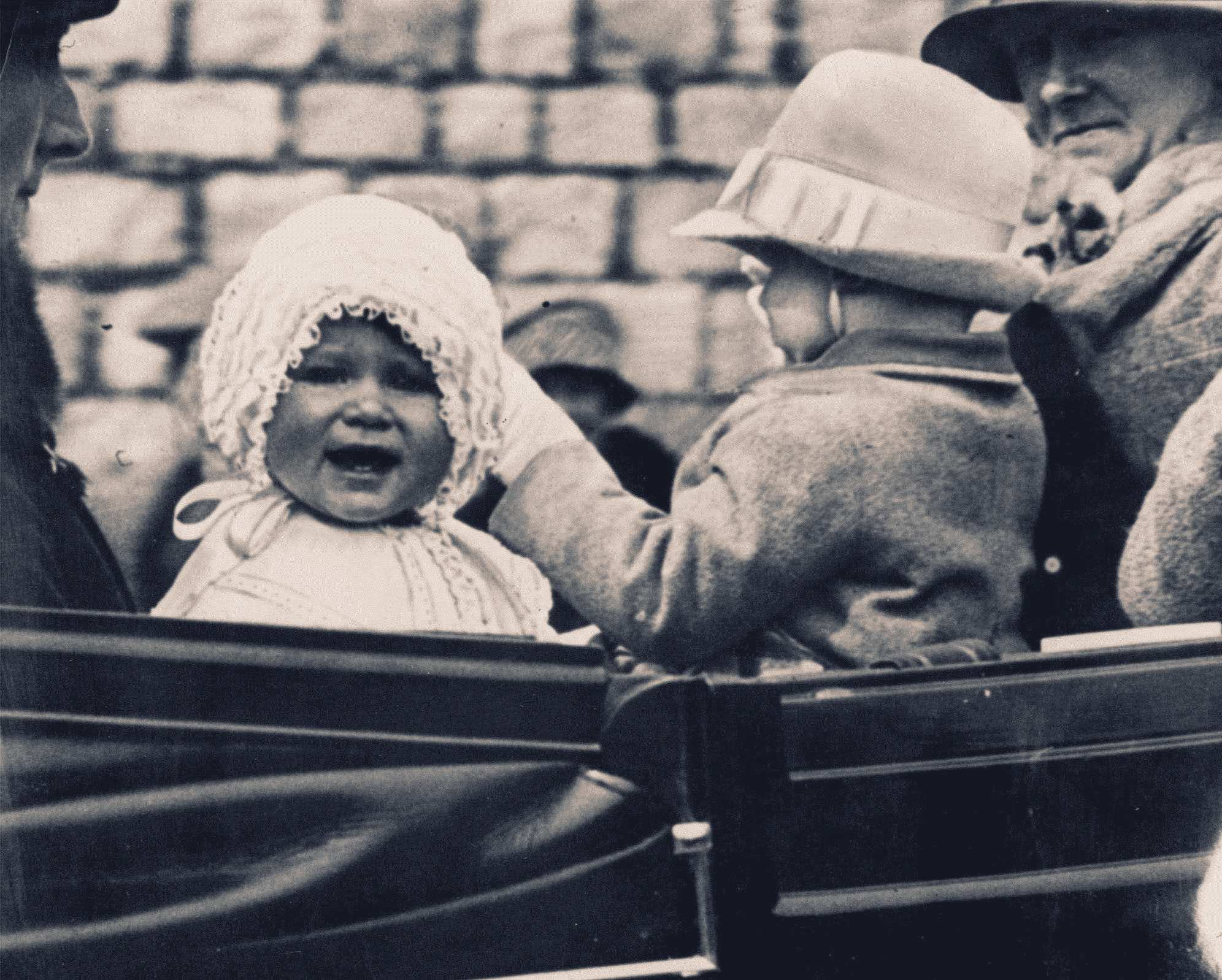 Princess Elizabeth, pictured as a baby, is taken for a ride in the grounds of Windsor Castle in 1927.