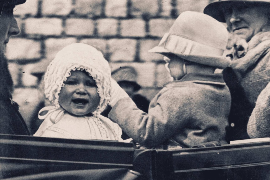 Princess Elizabeth, pictured as a baby, is taken for a ride in the grounds of Windsor Castle in 1927.