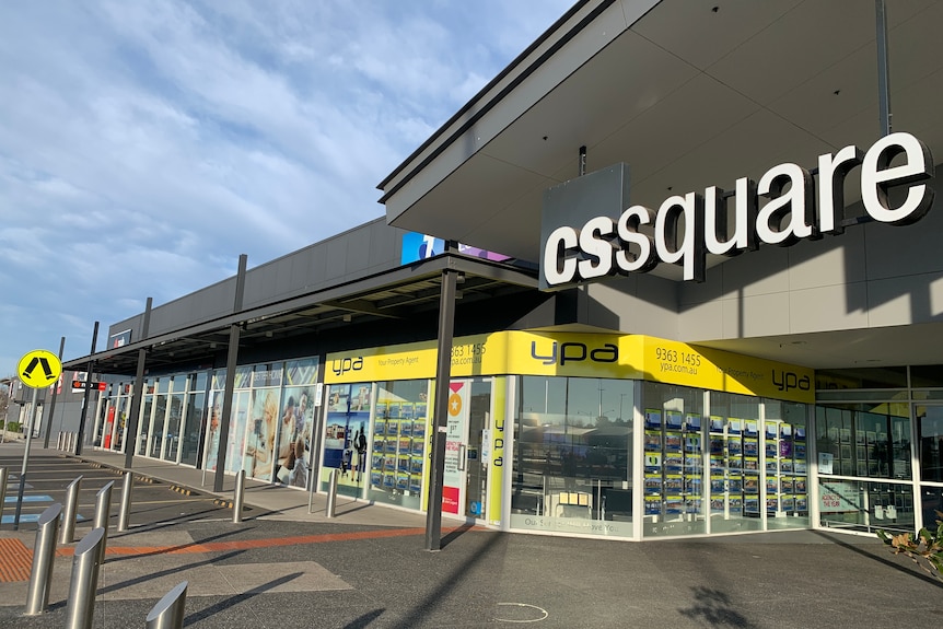 A sign reads 'CS Square' outside the shopping centre entrance, on a cloudy winter day.