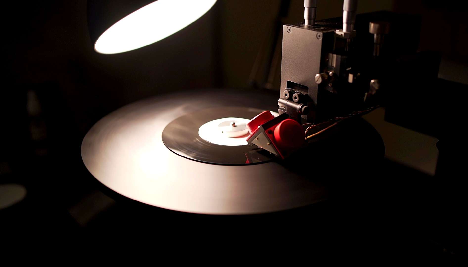 A piece of equipment cutting music onto vinyl
