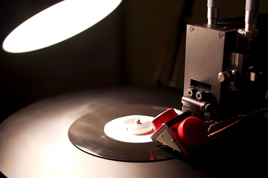A piece of equipment cutting music onto vinyl