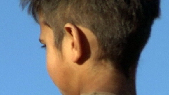 An Aboriginal child looks away from camera