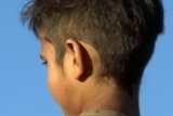 An Aboriginal child looks away from camera