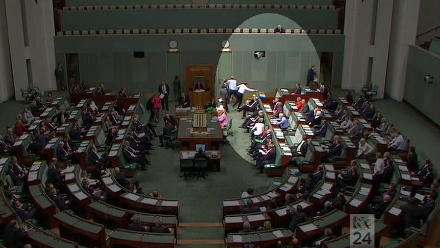 Members run for the door of the House of Representatives.