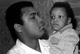 Muhammad Ali holding his 2 year old son  Muhammad Ali in 1975.