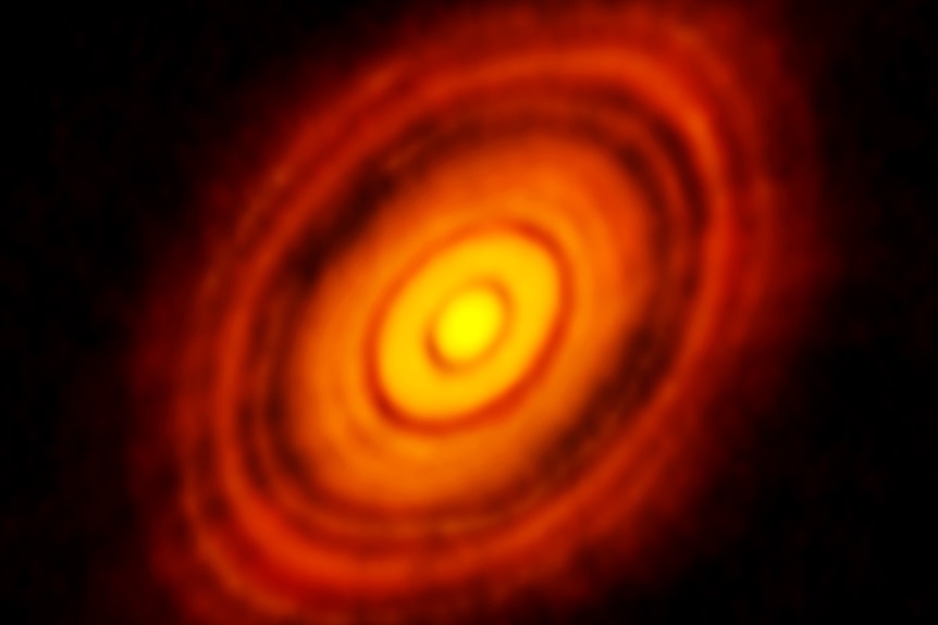 A famous image from ALMA showing the glowing disc around a young star, including gaps where the planets are forming.