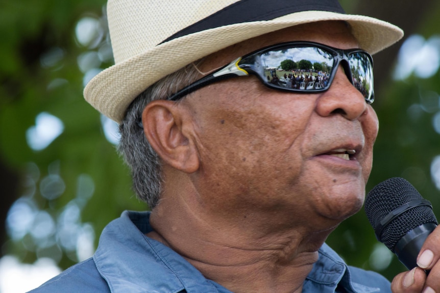 indigenous man in fedora with sunglasses