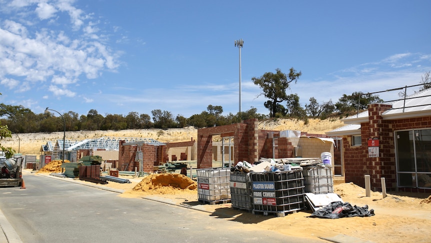 A street of new houses under construction.