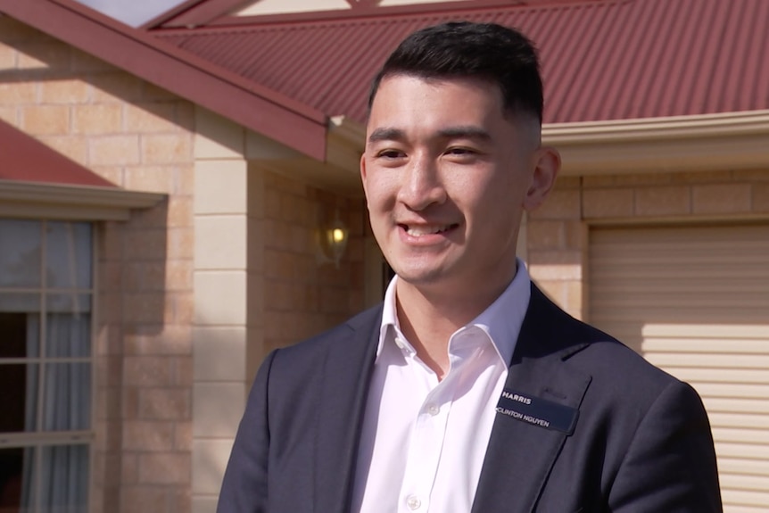 Clinton Nguyen standing outside a house smiling