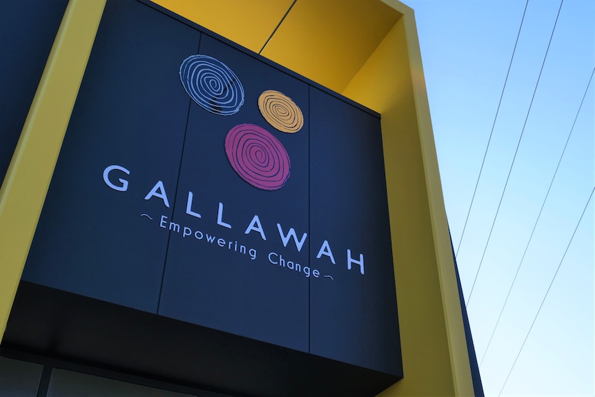 A sign on an office facade that reads "Gallawah — empowering change".