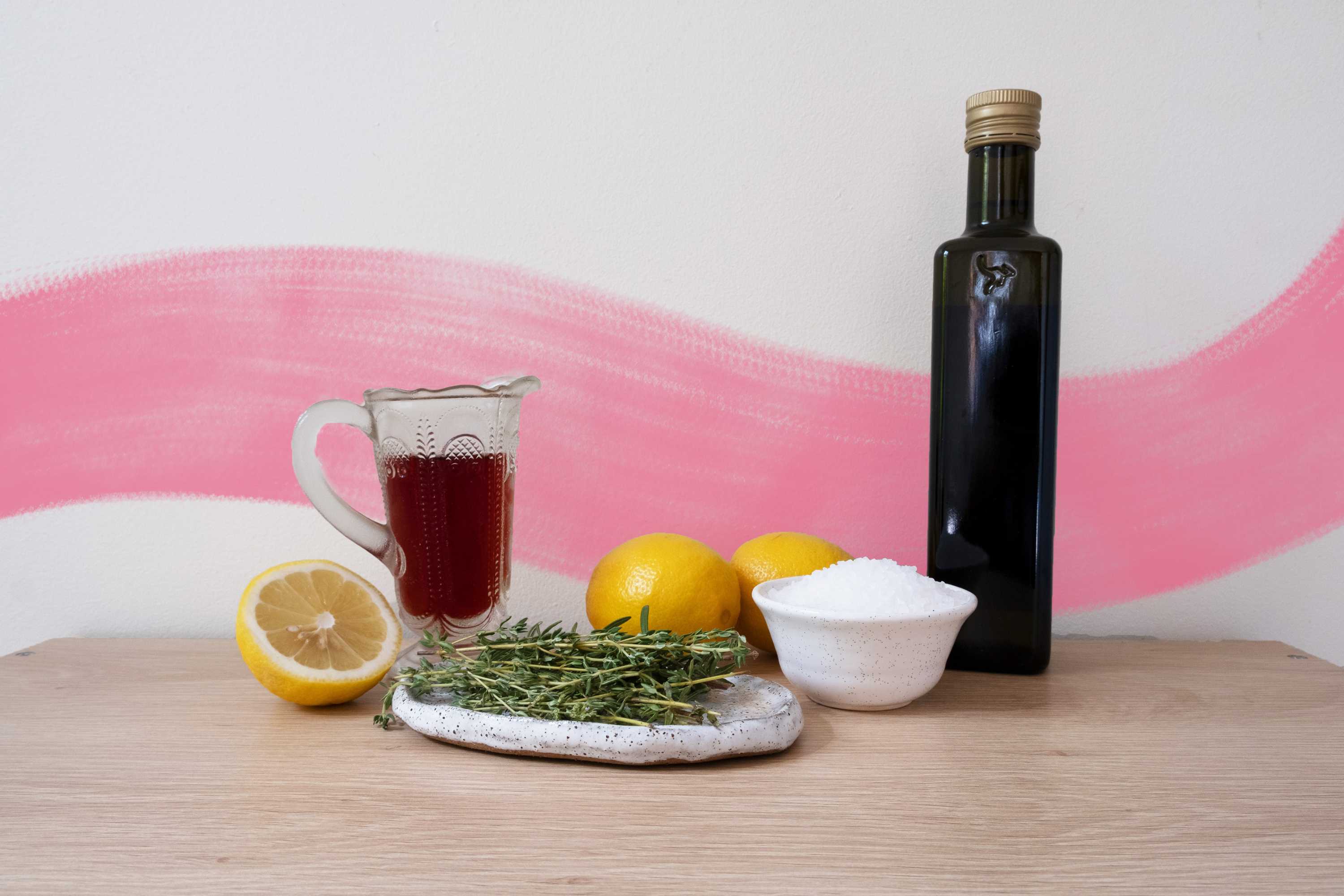 Lemons, thyme, flaky sea salt, olive oil and red wine vinegar in a story about chefs' must-have ingredients.