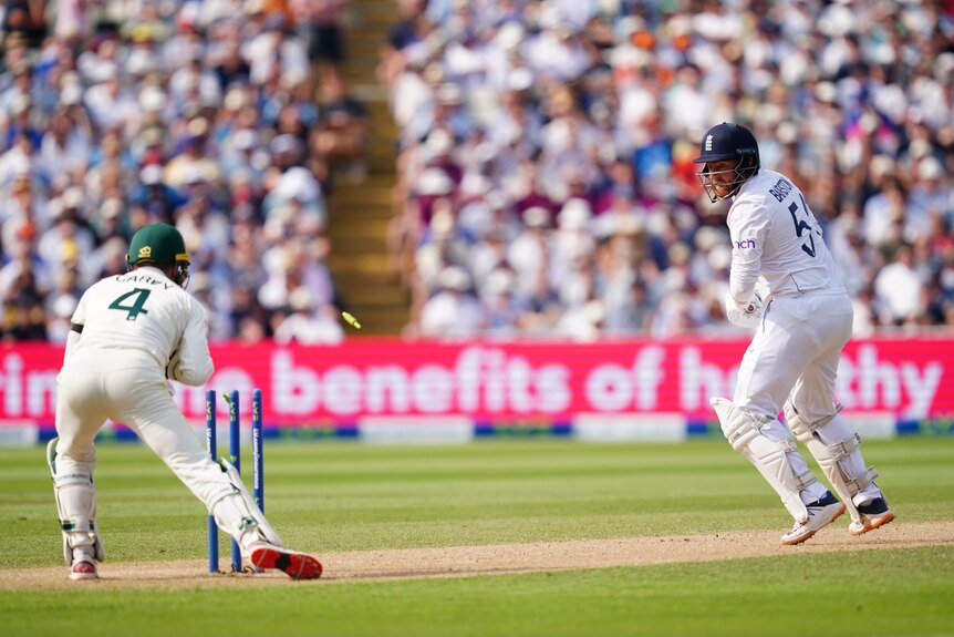 England batter Jonny Bairstow looks back as Australia wicketkeeper Alex Carey removes the bails.