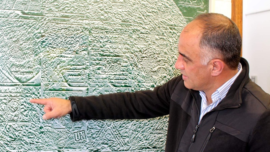 Ardeshir Gholipour with his artwork Earth.
