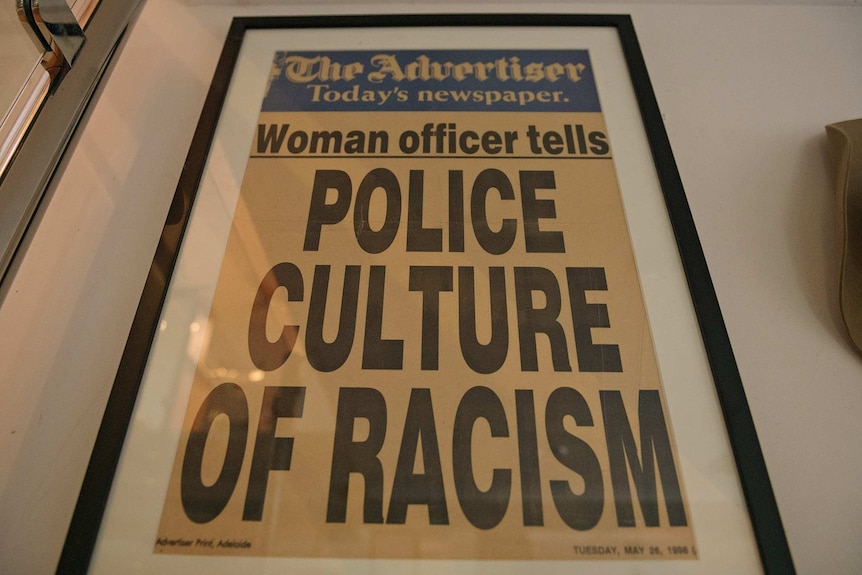 A historical front page of the Adelaide Advertiser reads: 'Woman officer tells police culture of racism'.