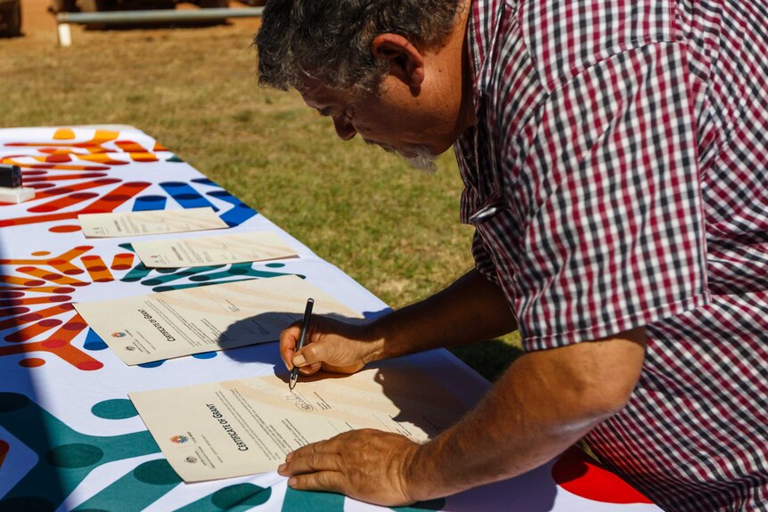 Traditional Owners sign the pastoral lease for Myroodah Station in Western Australia's far north.