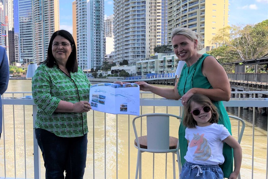 Grace Grace and Kate Jones hold a design plan together at Howard Smith Wharves