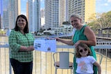 Grace Grace and Kate Jones hold a design plan together at Howard Smith Wharves
