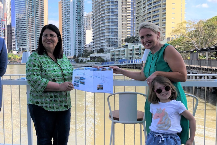 Grace Grace and Kate Jones hold a design plan together at Howard Smith Wharves