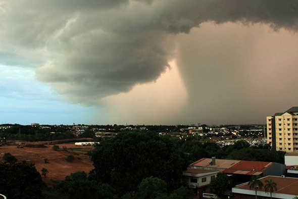 A heavy cloud bank looms over Darwin city.