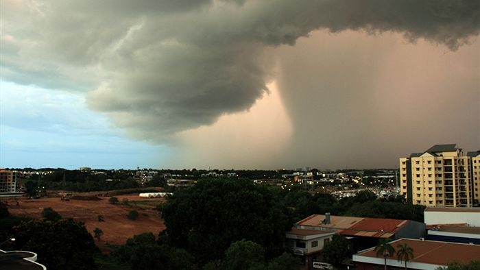 A heavy cloud bank looms over Darwin city.