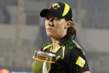Australia's Tahlia McGrath holds a trophy after beating India in a Twenty20 series.