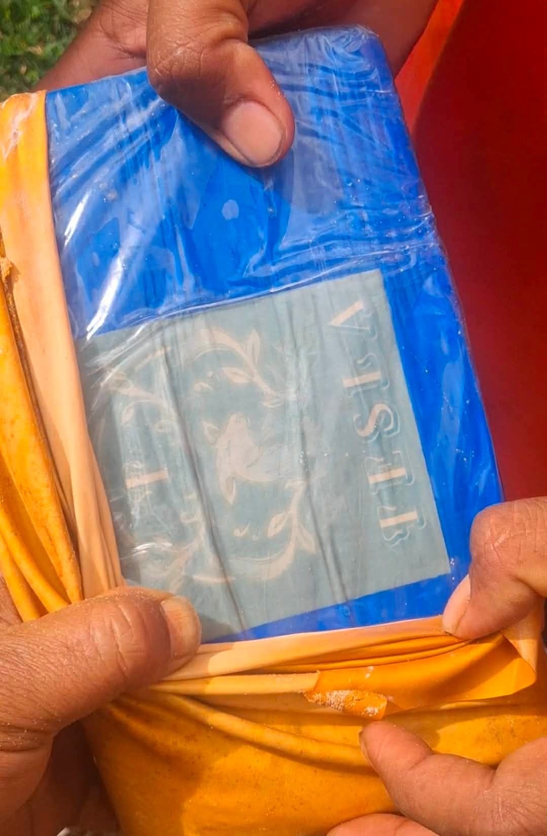 A close-up of a package with the word 'Tesla' stamped on the side