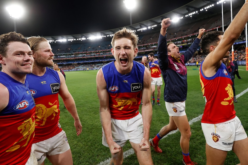 Harris Andrews yells in delight while leaving the MCG after a win