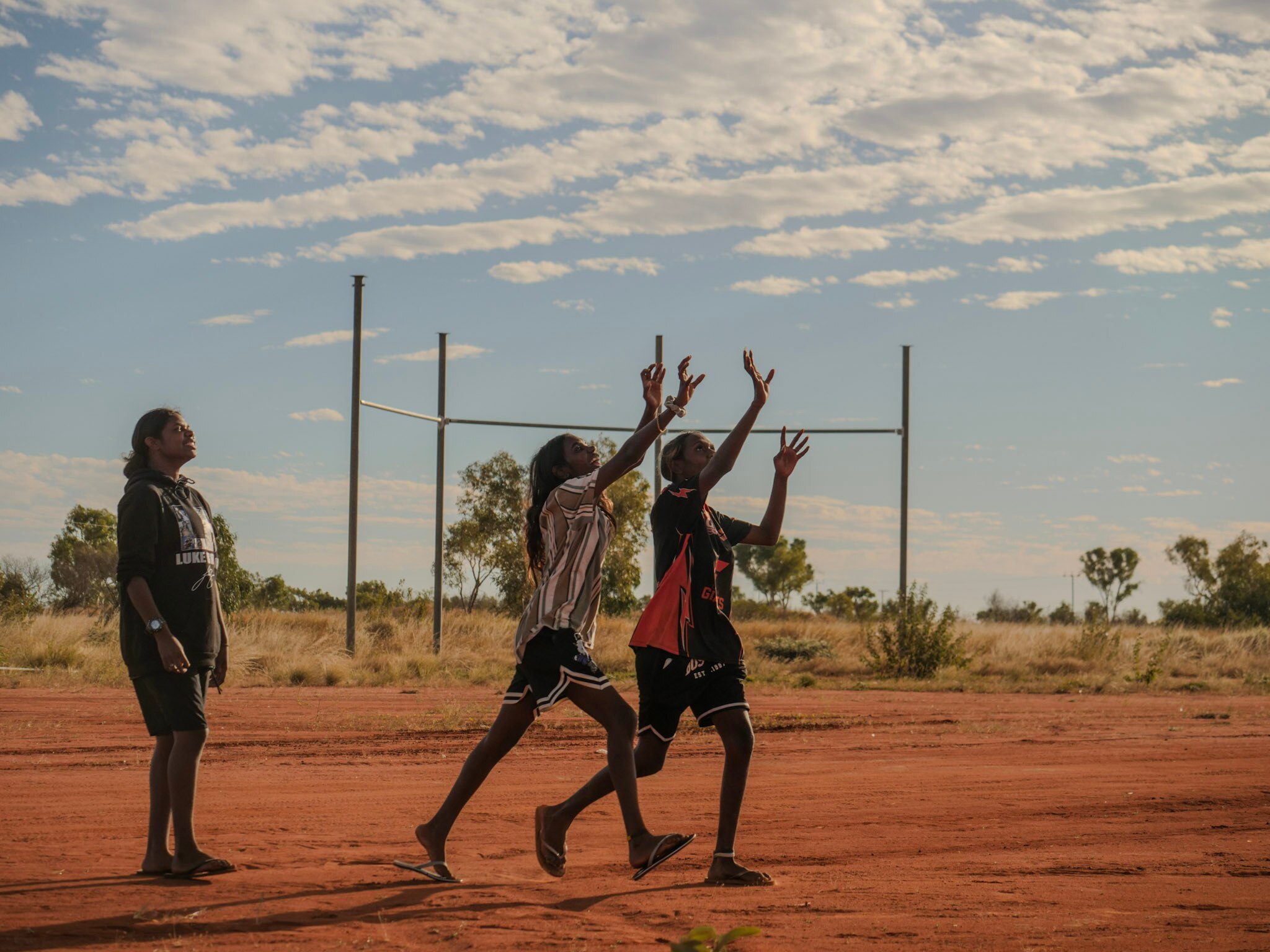 Girls reaching to catch football