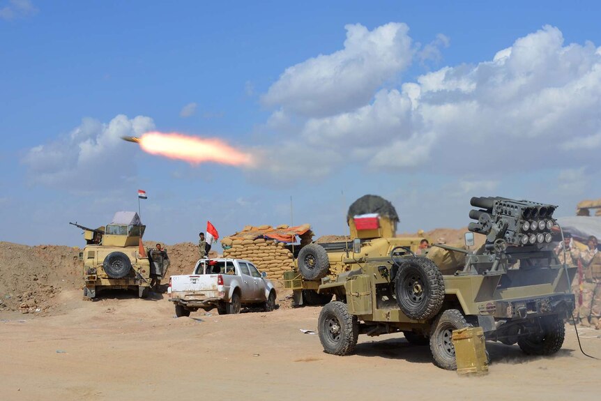 Iraqi government forces and allied militias fire weaponry in battle for Tikrit
