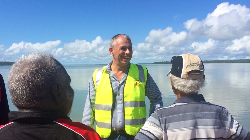 NT Chief Minister Adam Giles at Port Melville speaking to Tiwi Traditional Owners Gibson Illortaminni and Cyril Kalippa