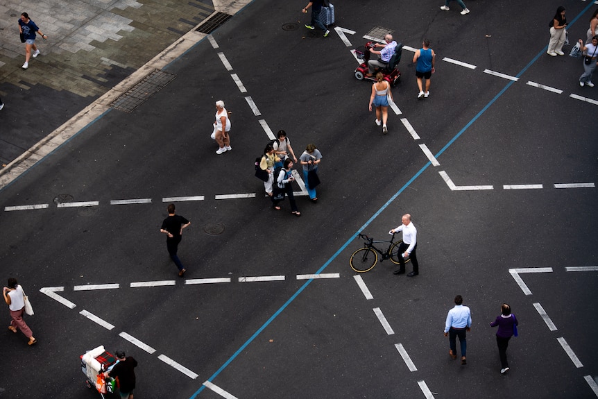 An aerial view of people crossing the road.