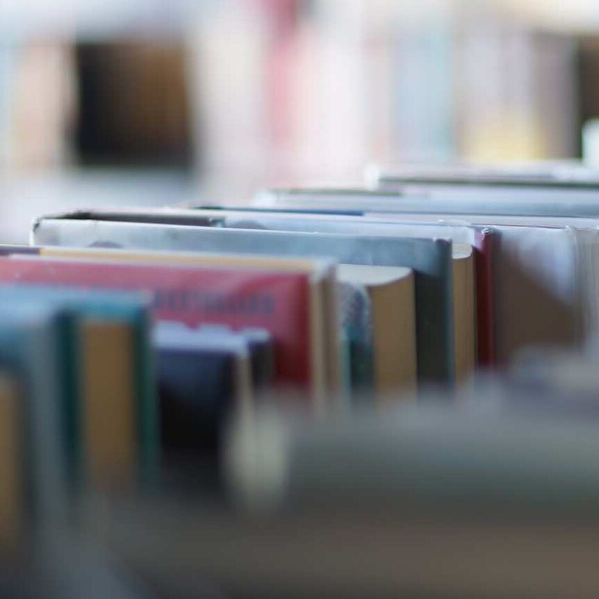 A close up of books on a shelf in a library.